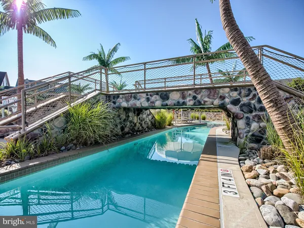 a view of swimming pool with a garden and seating area