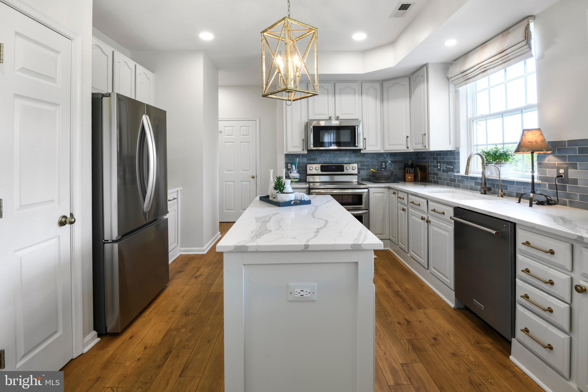 9105 Hendry Terrace Frederick, MD 21704 - Photo 6 of 51 a kitchen with a sink a counter top space stainless steel appliances and cabinets