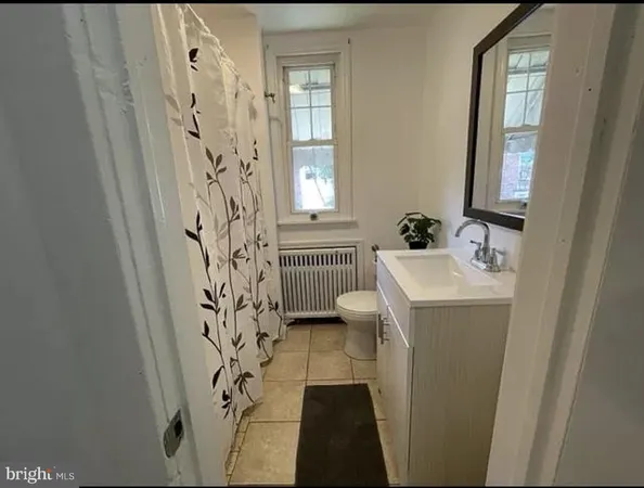 a bathroom with a sink a mirror a vanity and window