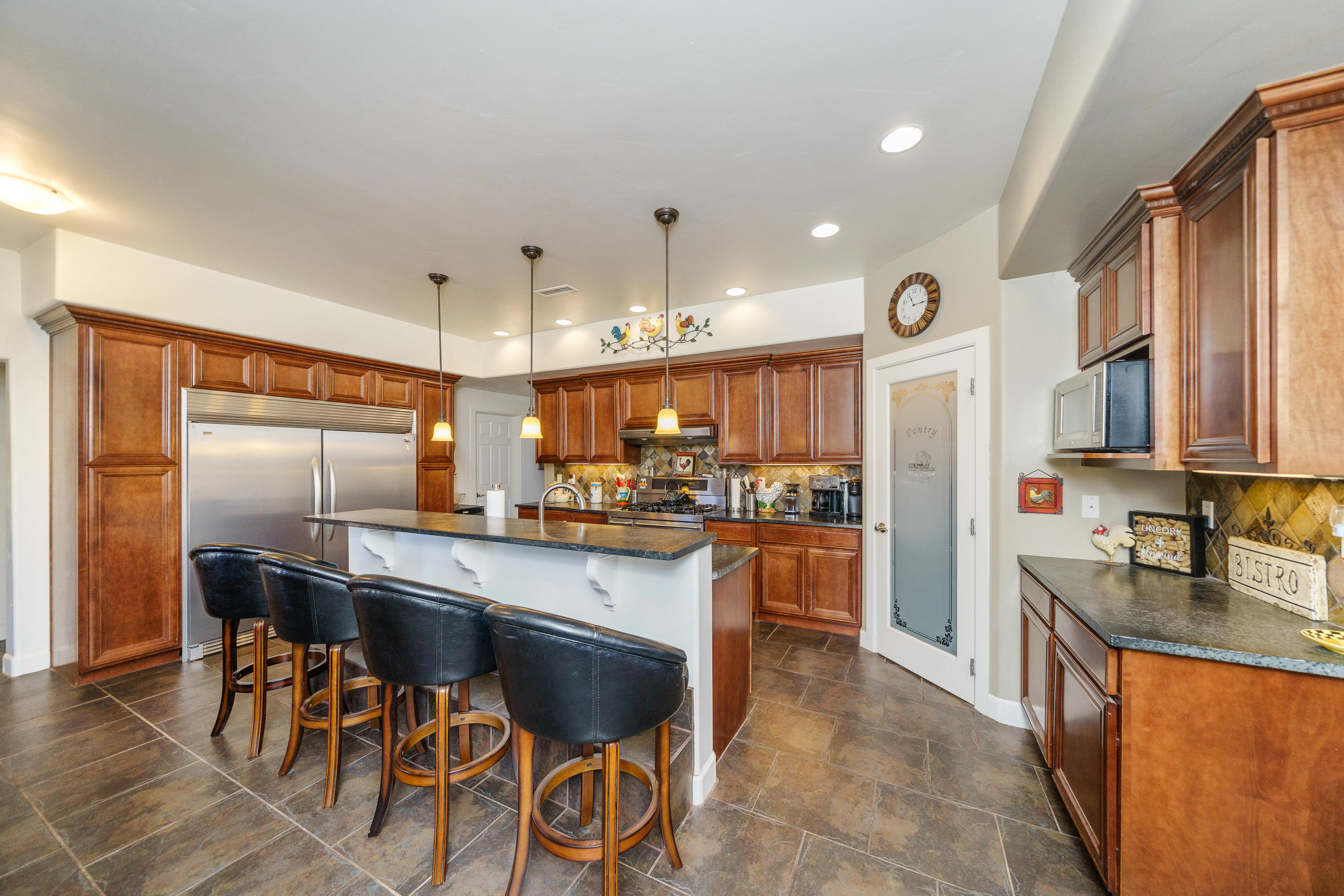 18000 North Lower Territory Road Prescott, AZ 86305 - Photo 12 of 42 a kitchen with stainless steel appliances granite countertop a refrigerator a sink dishwasher a stove and a dining table with wooden floor