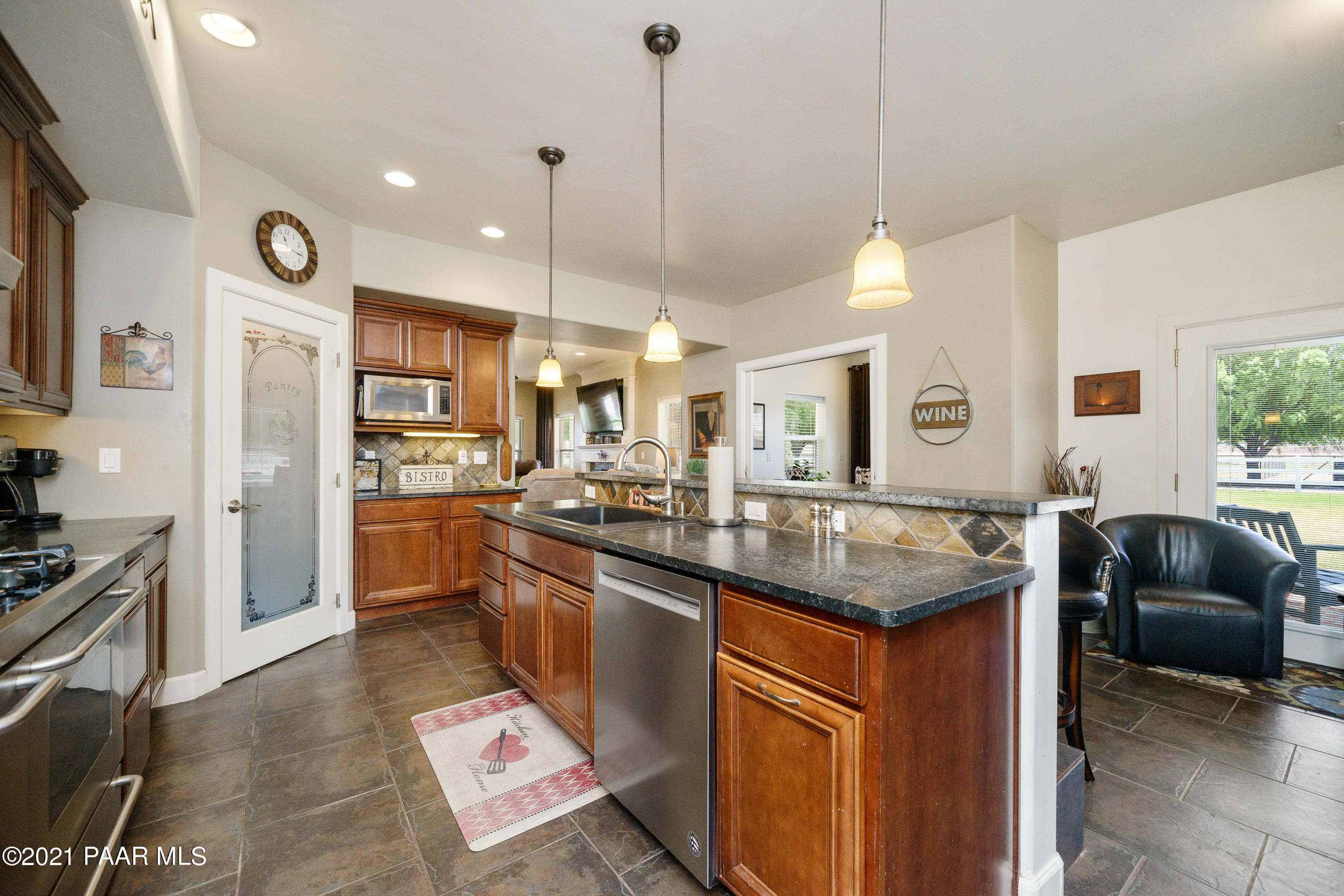 18000 North Lower Territory Road Prescott, AZ 86305 - Photo 14 of 42 a kitchen with stainless steel appliances granite countertop a sink a stove and a refrigerator