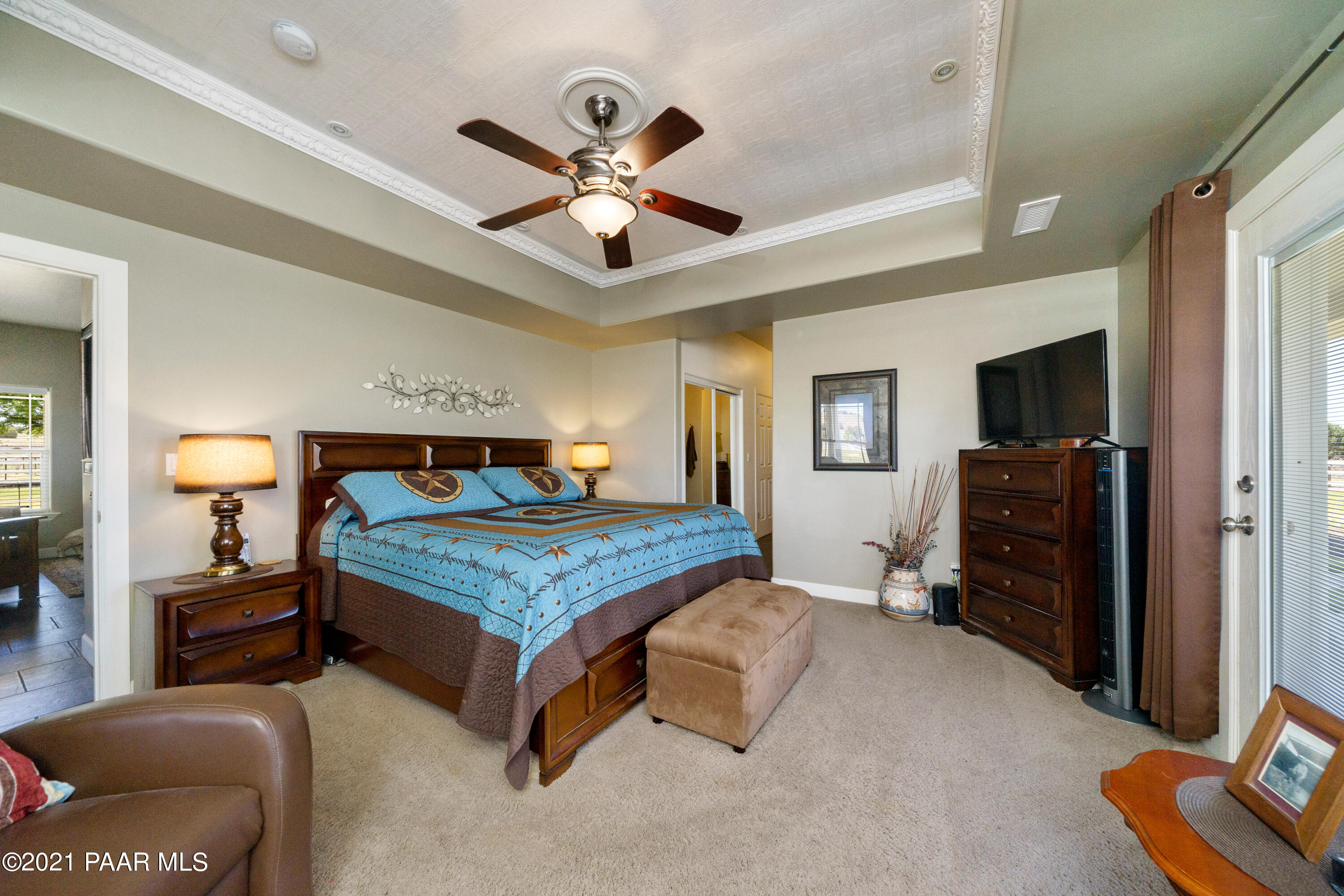 18000 North Lower Territory Road Prescott, AZ 86305 - Photo 19 of 42 a bedroom with a bed and a chandelier