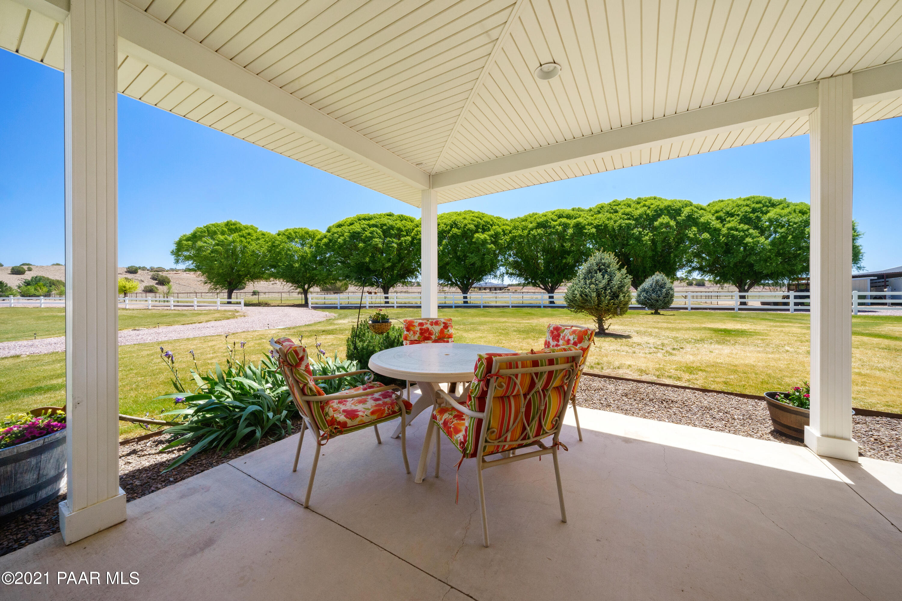 18000 North Lower Territory Road Prescott, AZ 86305 - Photo 4 of 42 a view of a swimming pool with a table and chairs under an umbrella