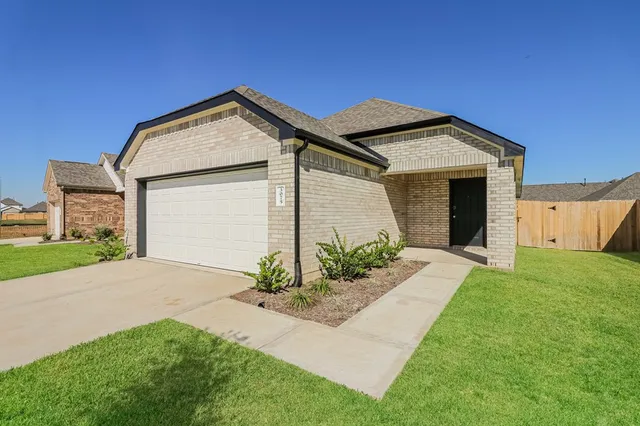 a view of a house with a yard and garage