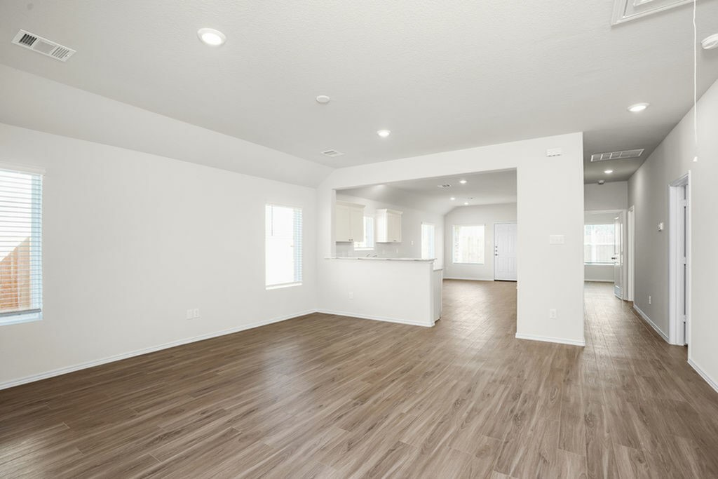3075 Wild Indigo Trail Brookshire, TX 77423 - Photo 11 of 16 a view of empty room with wooden floor and windows