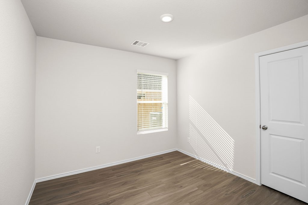 3075 Wild Indigo Trail Brookshire, TX 77423 - Photo 12 of 16 an empty room with wooden floor and window