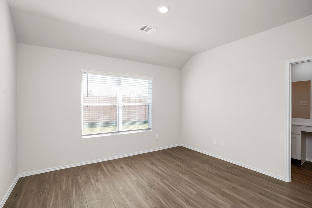 3075 Wild Indigo Trail Brookshire, TX 77423 - Photo 13 of 16 an empty room with wooden floor and windows