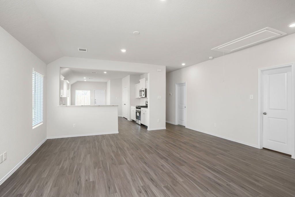 3075 Wild Indigo Trail Brookshire, TX 77423 - Photo 6 of 16 wooden floor in an empty room with a window