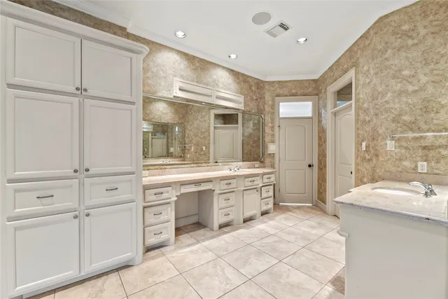 a bathroom with a granite countertop sink mirror and bathtub