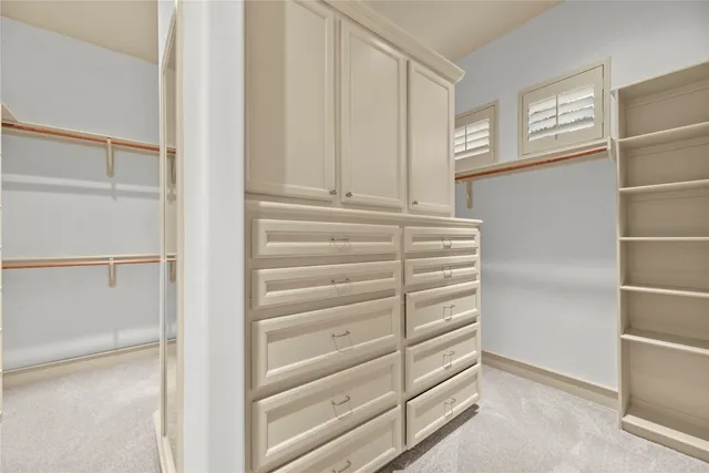 a view of walk in closet with empty racks