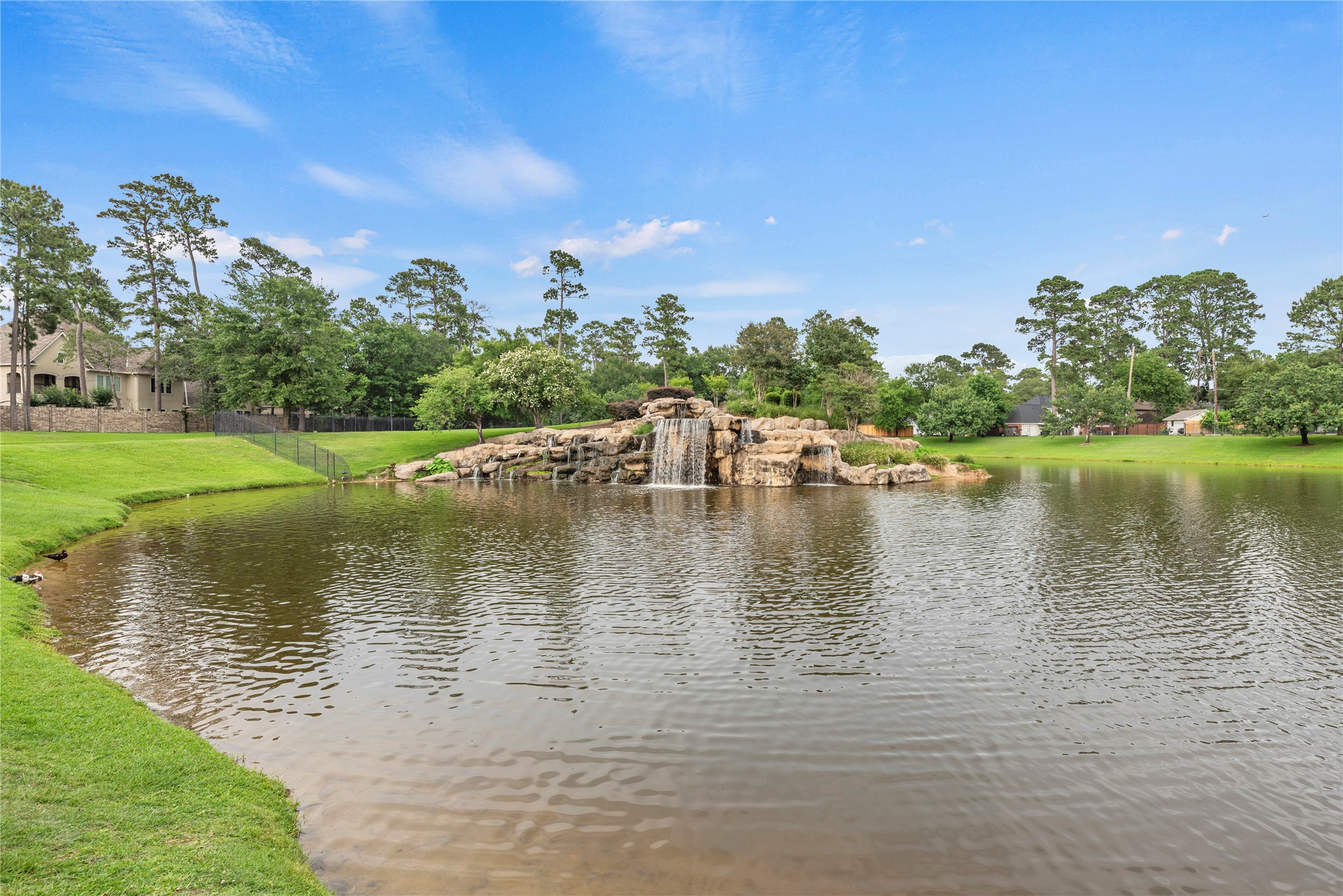 16610 Champagne Falls Court Spring, TX 77379 - Photo 43 of 45 a view of a lake with houses in the back