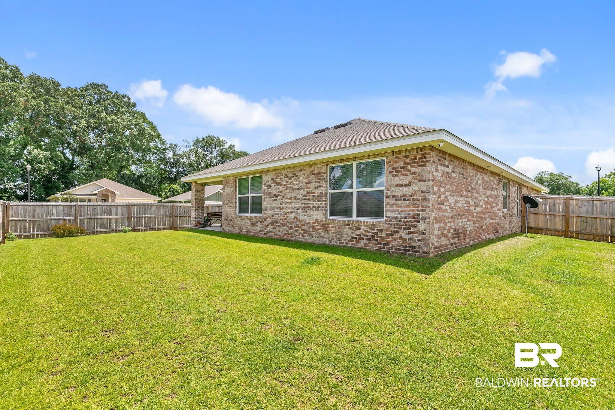 17217 REFLECTION Street Loxley, AL 36551 - Photo 44 of 83 Rear view of property with brick siding and a fenced backyard