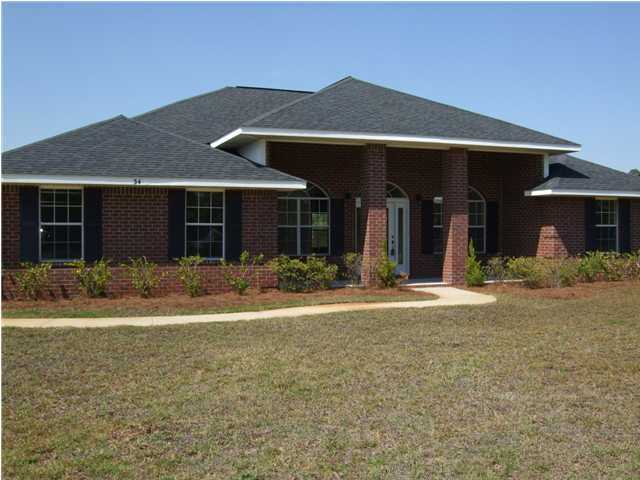 34 Shipwreck Road Santa Rosa Beach, FL 32459 - Photo 1 of 6 a front view of a house with a yard