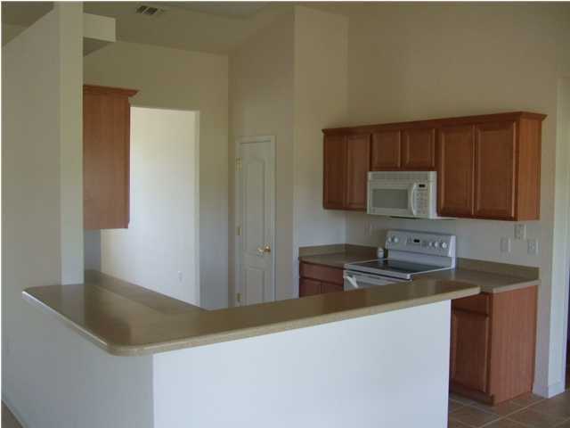 34 Shipwreck Road Santa Rosa Beach, FL 32459 - Photo 4 of 6 a kitchen with stainless steel appliances granite countertop a sink stove and microwave