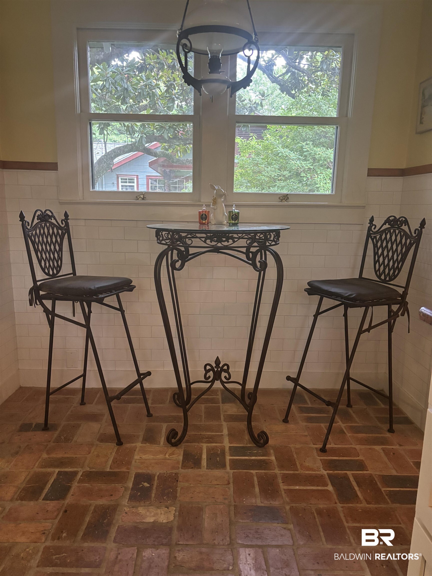 216 West Orange Avenue Foley, AL 36535 - Photo 15 of 37 Dining room with brick flooring, a chandelier, and tile walls
