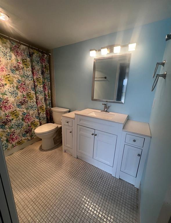 3050 Wolverton C, Unit 3050 Boca Raton, FL 33434 - Photo 11 of 19 a bathroom with a sink a toilet a mirror and shower