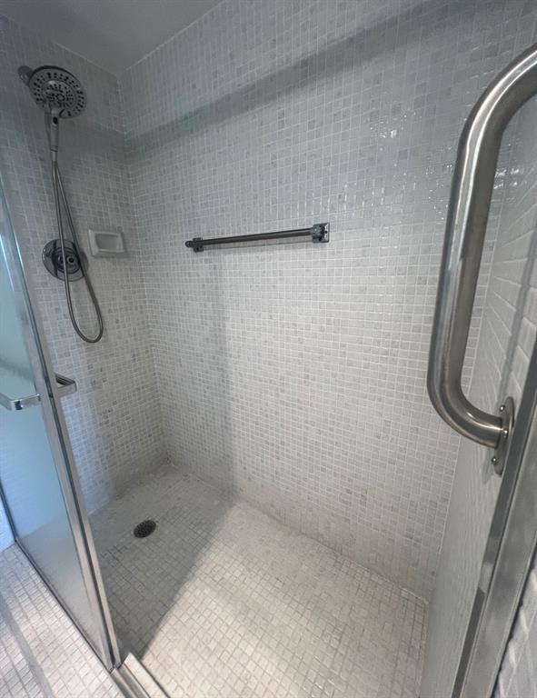 3050 Wolverton C, Unit 3050 Boca Raton, FL 33434 - Photo 18 of 19 a bathroom with a glass shower door