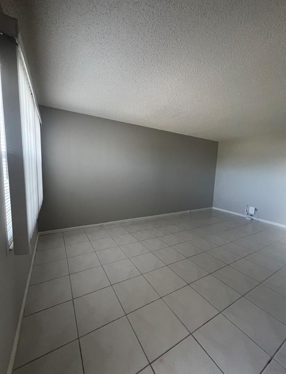 3050 Wolverton C, Unit 3050 Boca Raton, FL 33434 - Photo 4 of 19 an empty room with a bench
