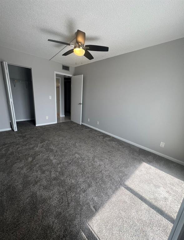 3050 Wolverton C, Unit 3050 Boca Raton, FL 33434 - Photo 6 of 19 an empty room with a chandelier fan and windows