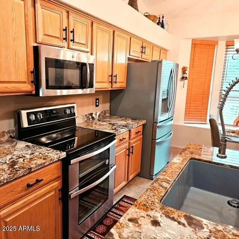 a kitchen with stainless steel appliances a stove microwave and refrigerator