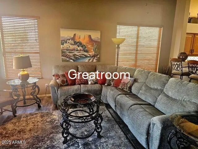 a blue couch sitting in a living room next to a window