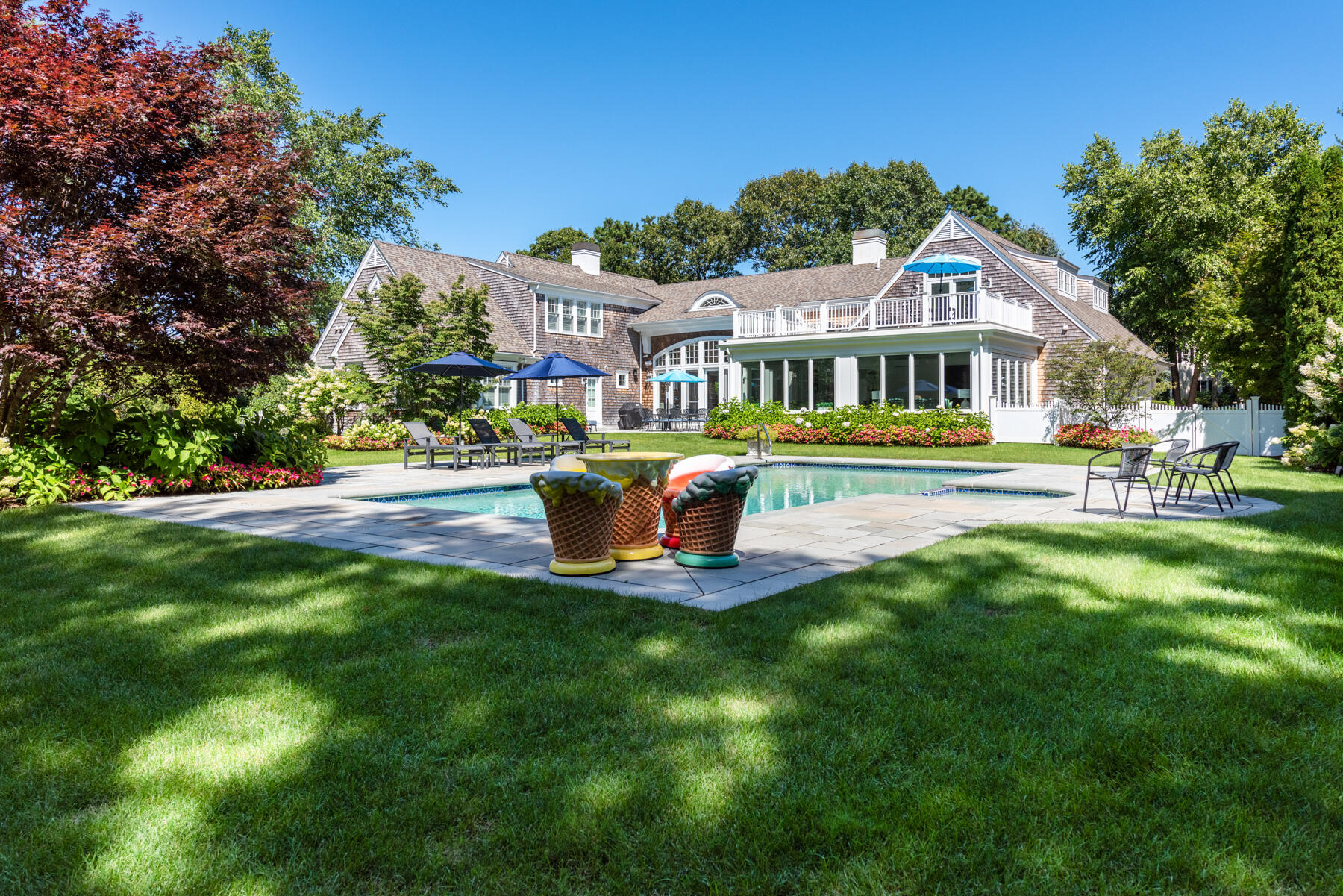 350 Windswept Way Osterville, MA 02655 - Photo 2 of 32 a front view of a house with a yard table and chairs