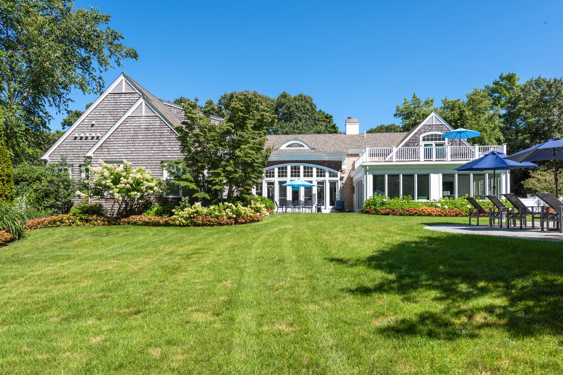 350 Windswept Way Osterville, MA 02655 - Photo 4 of 32 a front view of a house with a garden