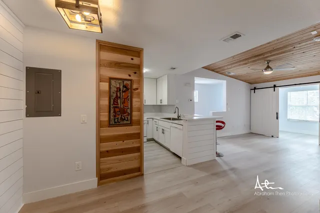 a view of kitchen and hall with wooden floor