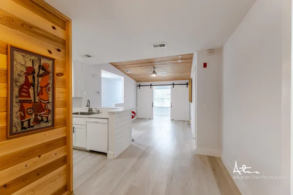 a kitchen with granite countertop a stove and wooden floor