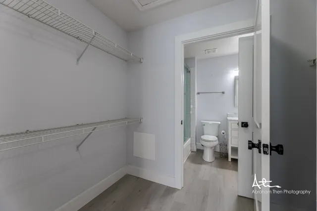 a bathroom view with a toilet and a shower