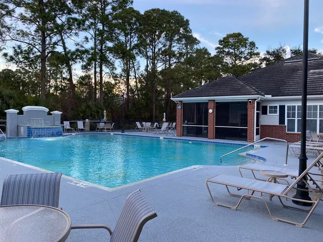 a view of a house with backyard porch and sitting area