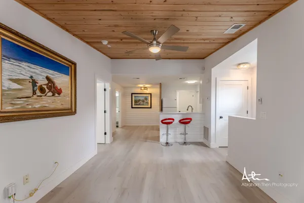 a view of a livingroom with wooden floor and furniture