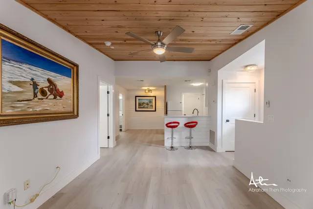 a view of a livingroom with wooden floor and furniture