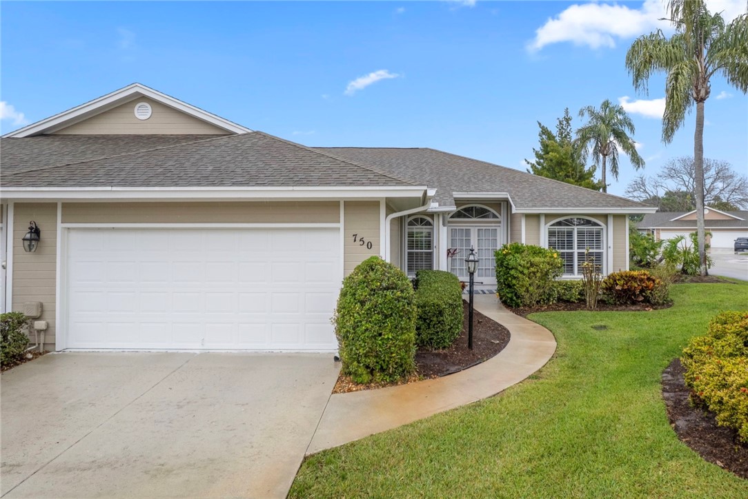 750 Timber Ridge Trail Southwest Vero Beach, FL 32962 - Photo 20 of 26 a front view of a house with a yard