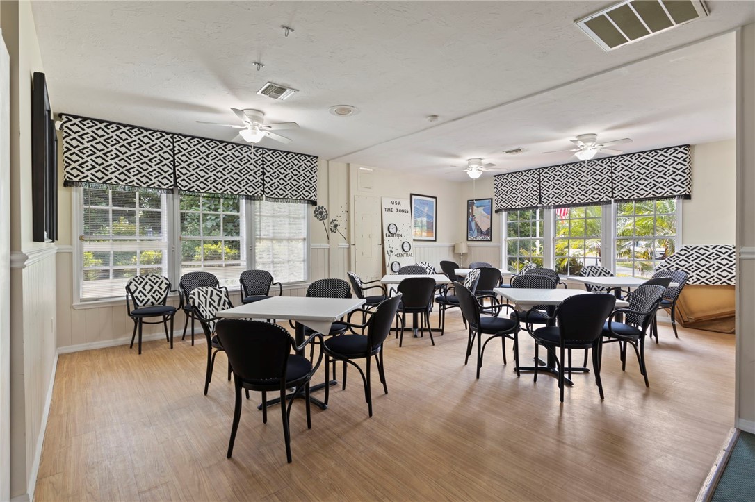 750 Timber Ridge Trail Southwest Vero Beach, FL 32962 - Photo 25 of 26 a view of a dining room and livingroom with lots of furniture window and wooden floor