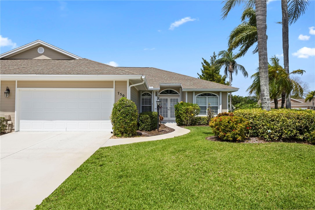 750 Timber Ridge Trail Southwest Vero Beach, FL 32962 - Photo 26 of 26 a front view of a house with a yard