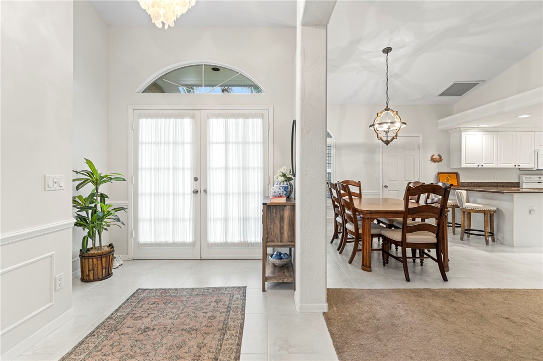 750 Timber Ridge Trail Southwest Vero Beach, FL 32962 - Photo 3 of 26 a view of a dining room with furniture and a chandelier