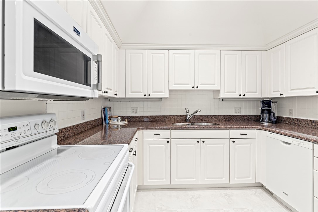 750 Timber Ridge Trail Southwest Vero Beach, FL 32962 - Photo 5 of 26 a kitchen with granite countertop white cabinets and stainless steel appliances