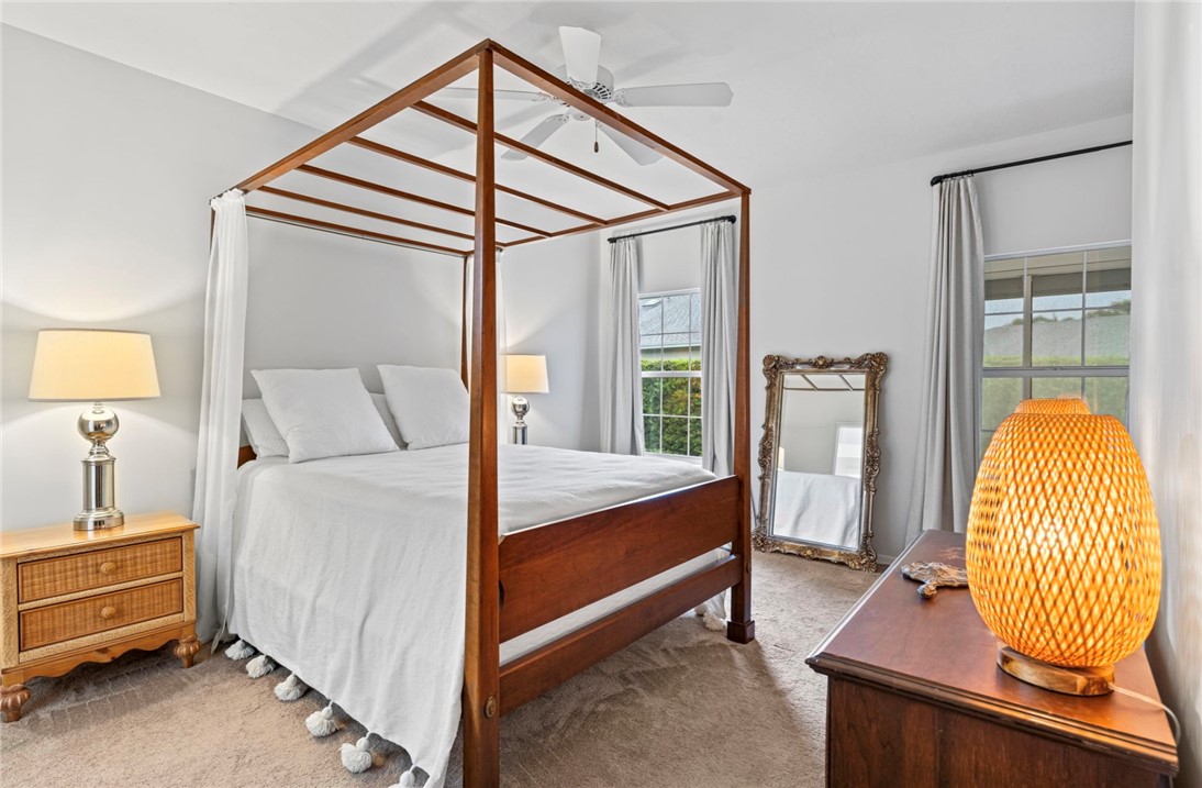 750 Timber Ridge Trail Southwest Vero Beach, FL 32962 - Photo 9 of 26 a bedroom with a bed and wooden floor