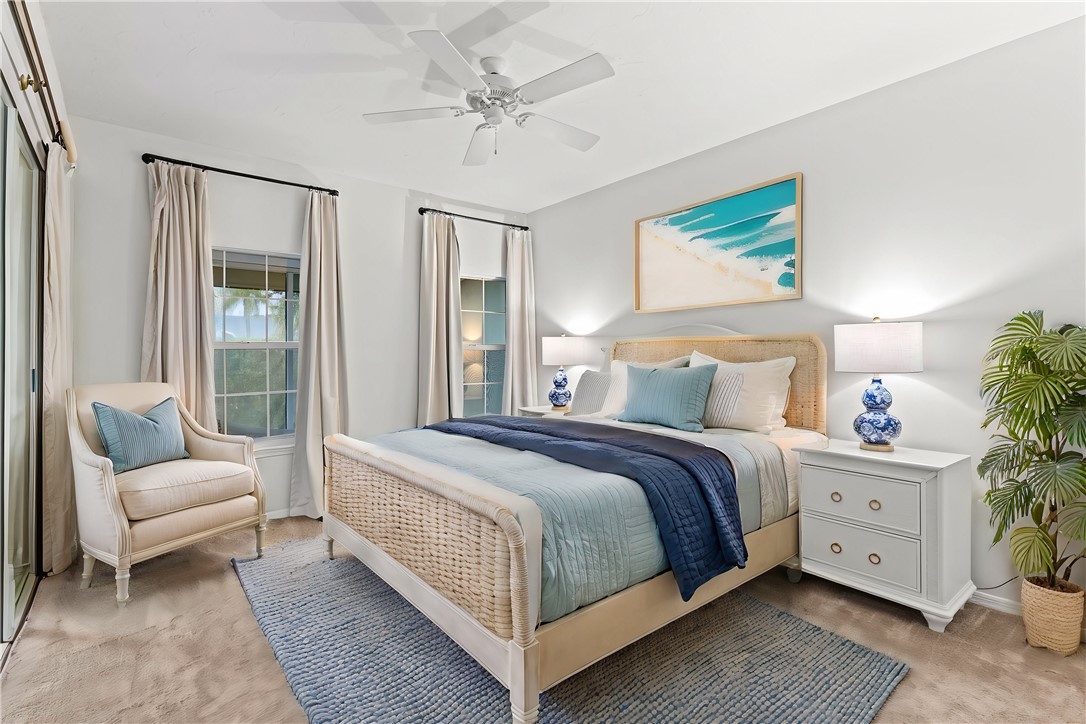 750 Timber Ridge Trail Southwest Vero Beach, FL 32962 - Photo 10 of 26 a bedroom with a large bed and a couch