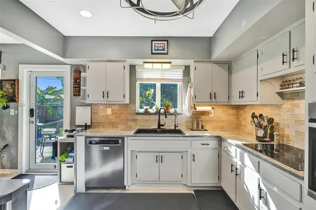 a room with lots of white furniture and window