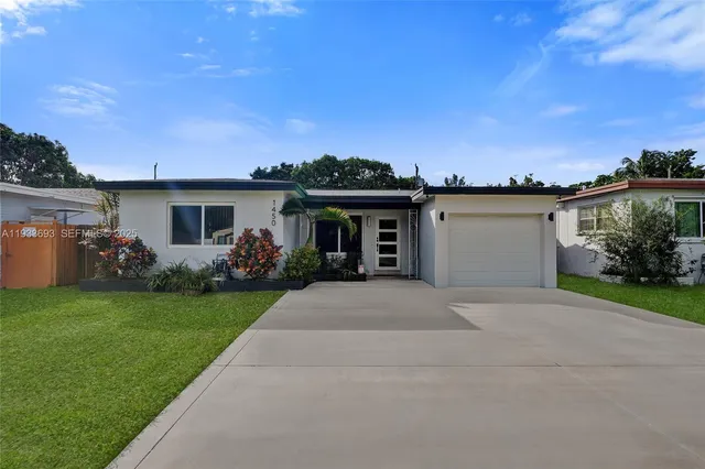 a front view of a house with a garden and yard