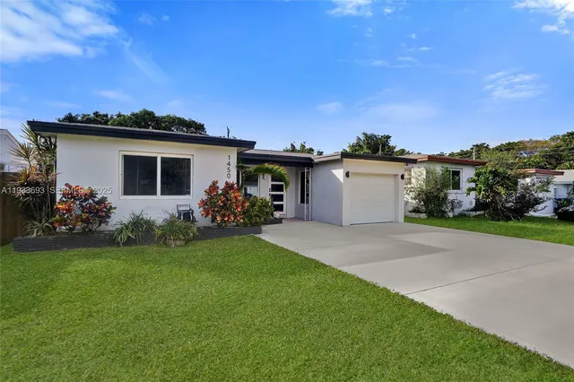 a view of a house with potted plants