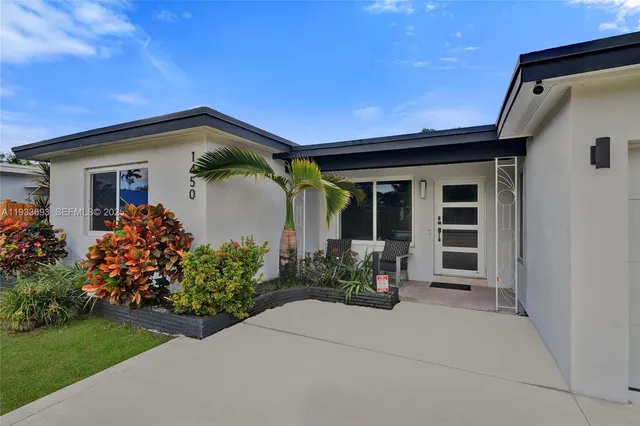 a living room with furniture fireplace and a large window