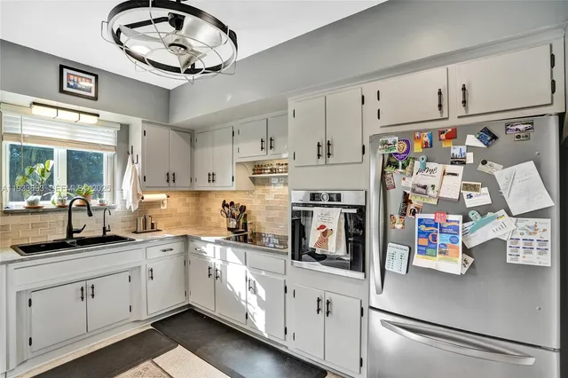 a kitchen with stainless steel appliances granite countertop a stove and cabinets