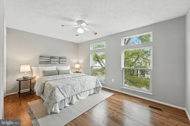 a bedroom with a large bed and a window