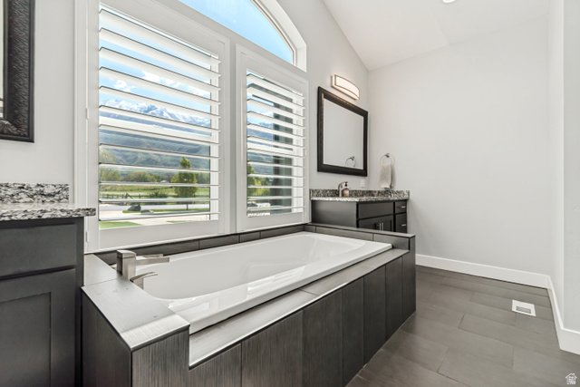 1526 South 500 West Mapleton, UT 84664 - Photo 10 of 54 Bathroom with two vanities, a bath, lofted ceiling, and healthy amount of natural light