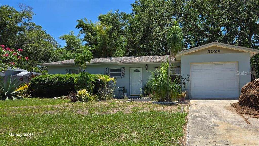 3026 19th Place Southwest Largo, FL 33774 - Photo 1 of 1 a front view of a house with a yard