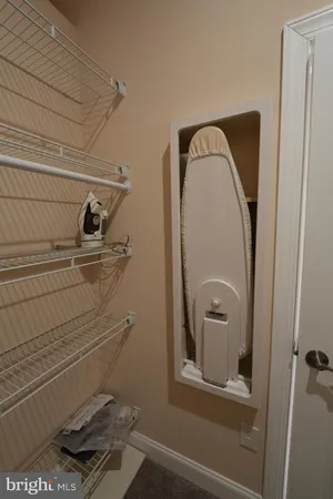 a spacious bedroom with a bed and a flat screen tv
