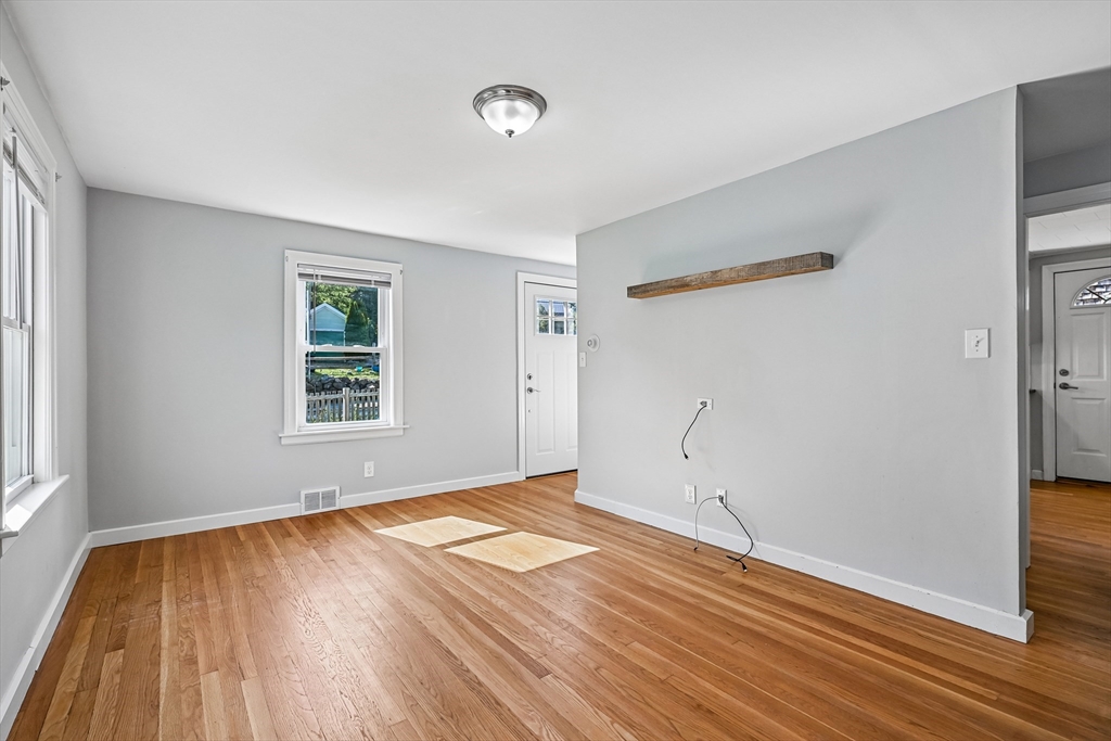 42 East Main Street Gloucester, MA 01930 - Photo 3 of 25 an empty room with wooden floor and windows